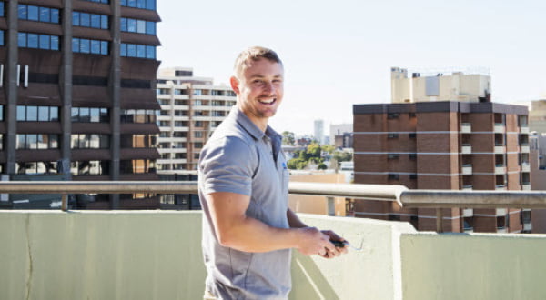 Man on the rooftop smiling at the camera