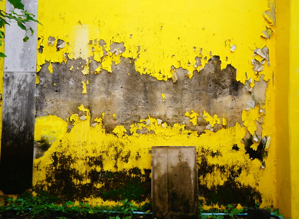 Yellow wall with rust stains