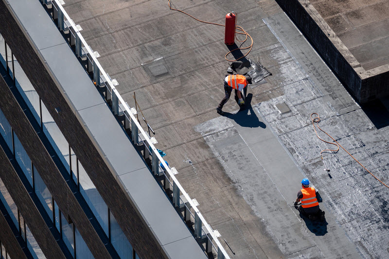 Professional bitumen waterproofing on a flat building