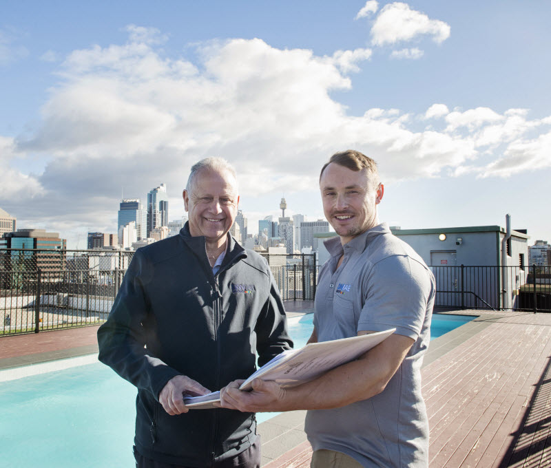Two men posing at the camera at the rooftop