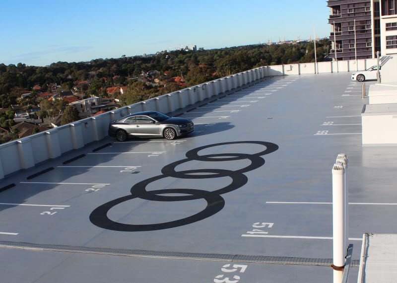 Rooftop parking with Audi logo on the floor