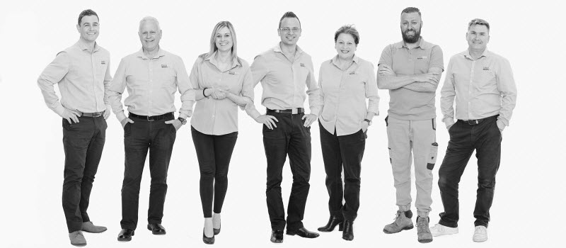 Team members smiling at the camera